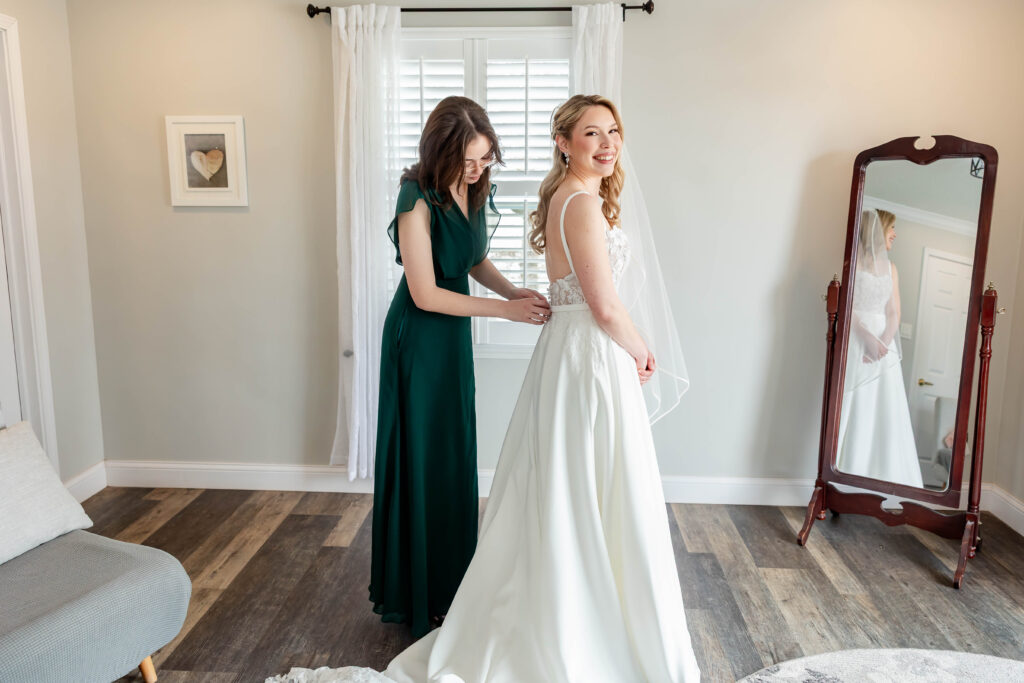 Bride Jillian Baker getting ready at Piazza Messina in Cottleville MO with White Traditions gown