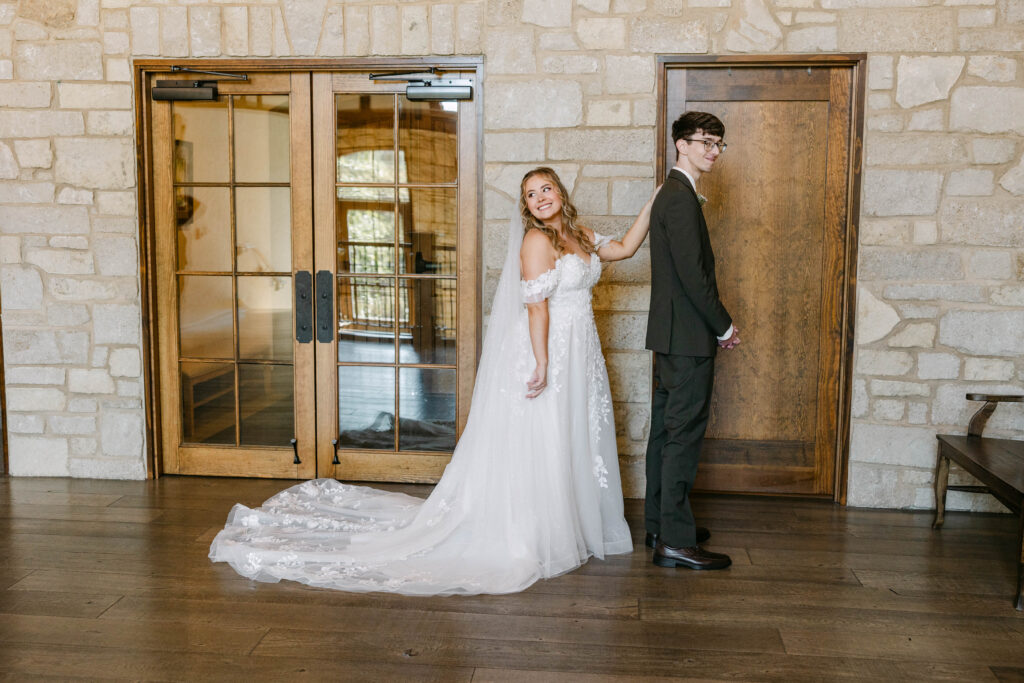 First look on the upper stairs between bride Kenzie and groom Tyler at Silver Oaks Chateau