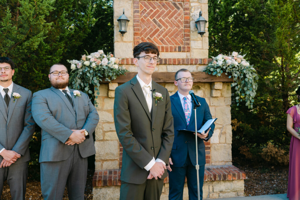 Outdoor wedding ceremony in front of fireplace at Silver Oaks Chateau, Pacific MO