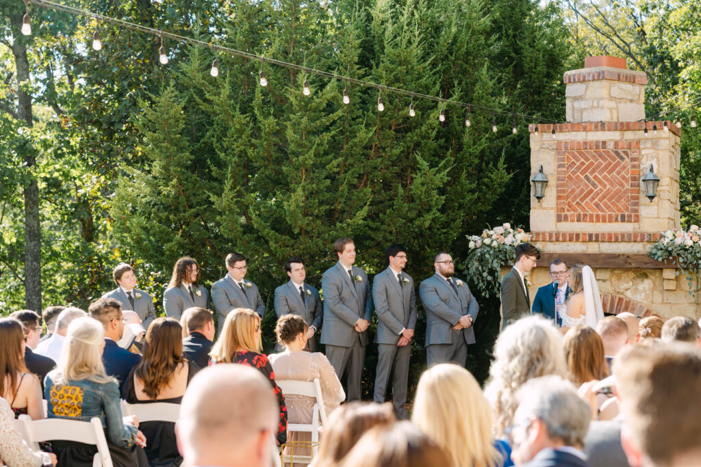 Outdoor wedding ceremony in front of fireplace at Silver Oaks Chateau, Pacific MO