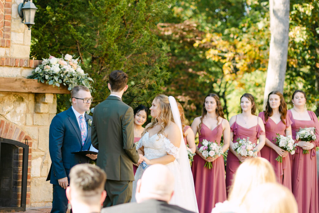 Outdoor wedding ceremony in front of fireplace at Silver Oaks Chateau, Pacific MO