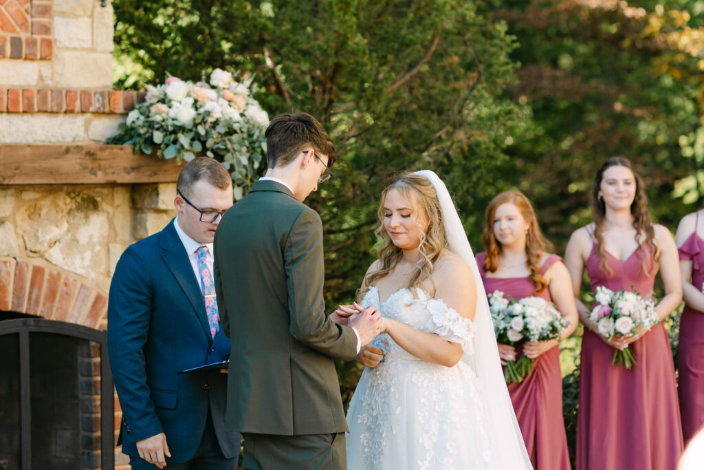 Outdoor wedding ceremony in front of fireplace at Silver Oaks Chateau, Pacific MO